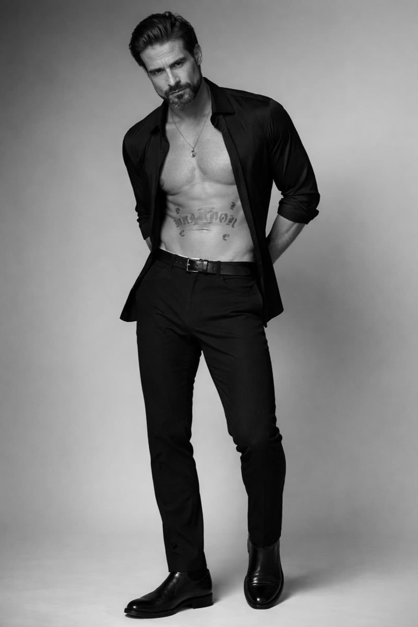 Brandon Mills — black-and-white studio portrait in a black shirt